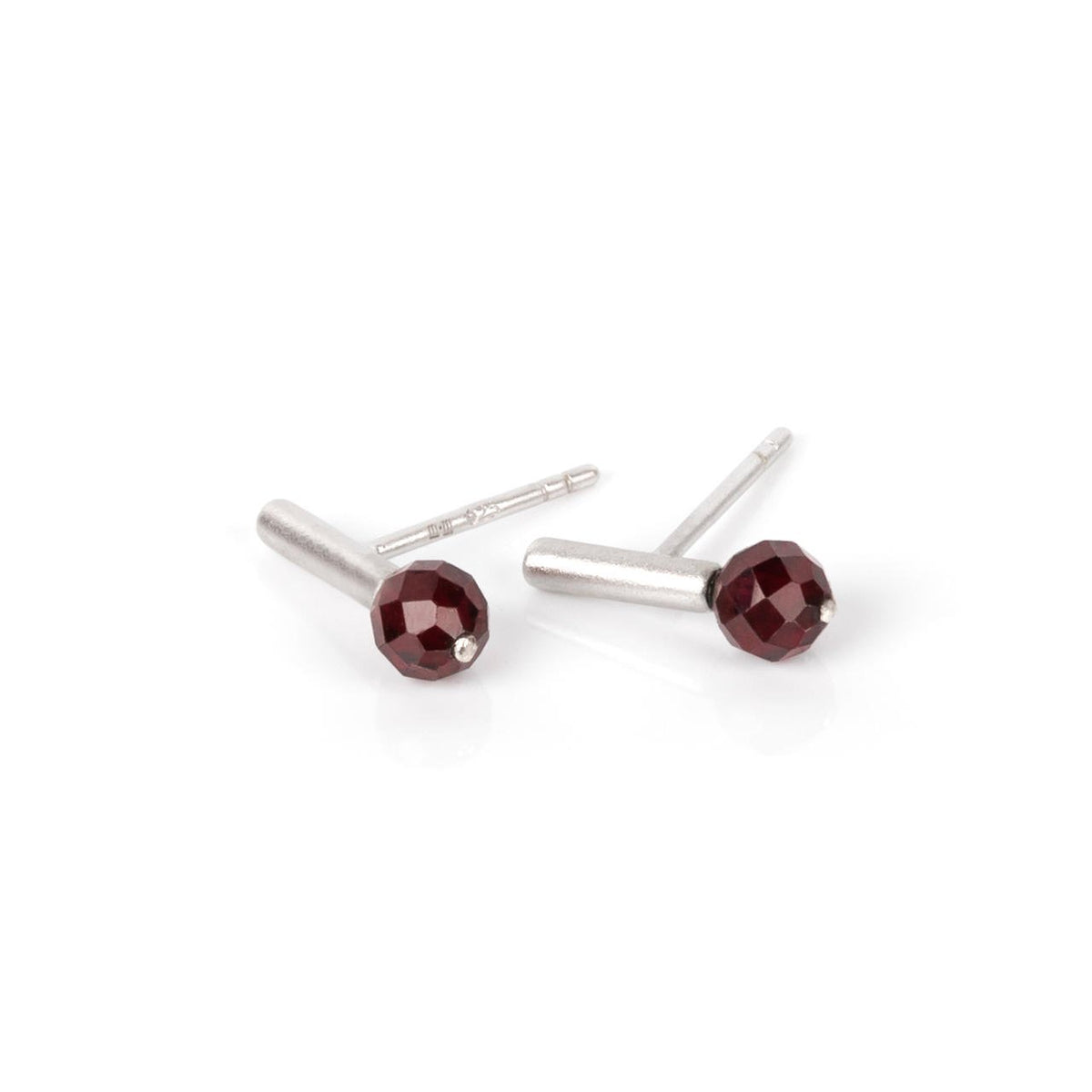 1. Pair of MyaMoon Light It Up earrings in silver with faceted red garnet stones on a white background