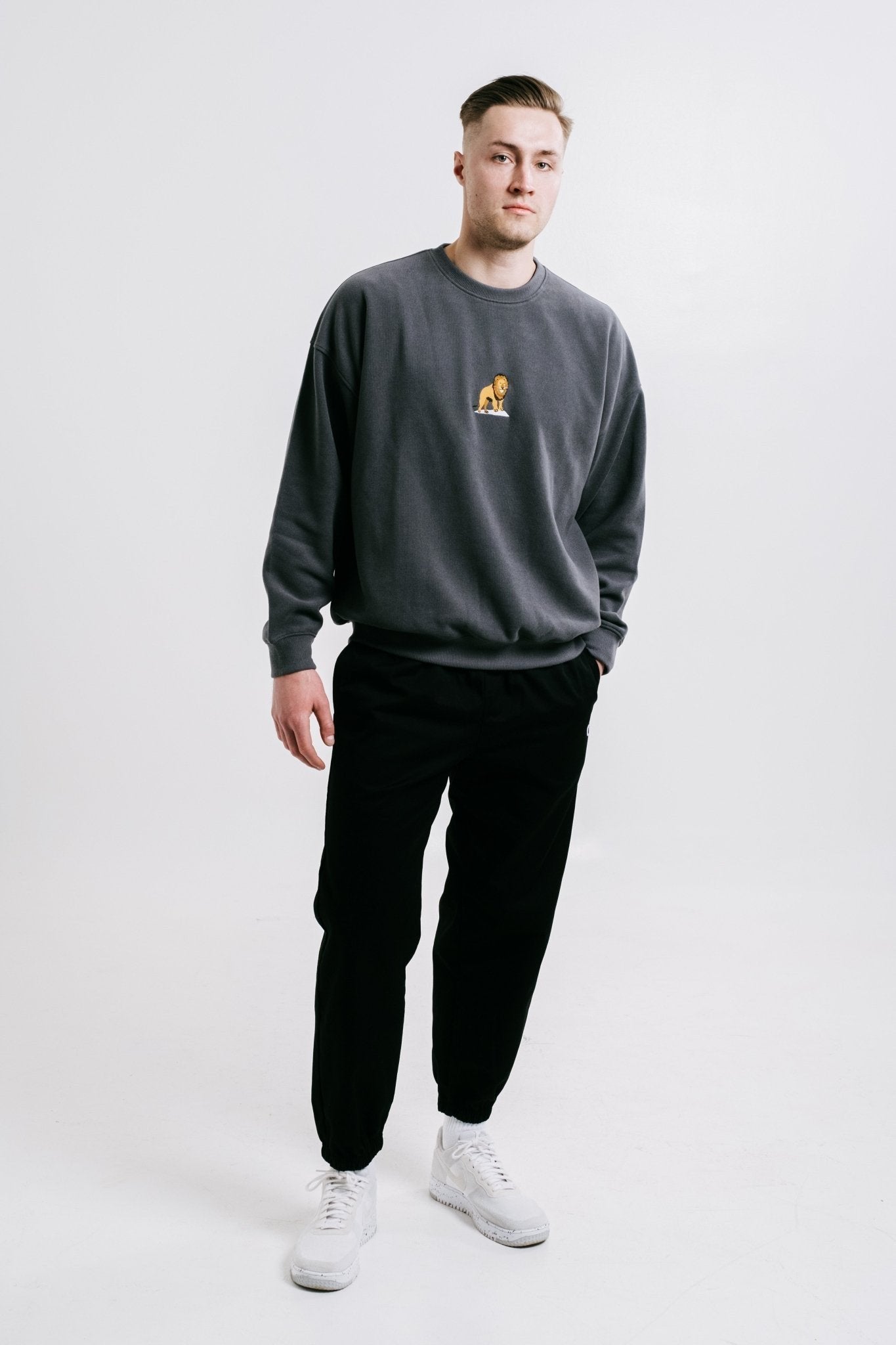 1. Unisex anthracite Lion Sweatshirt by Sossu worn by male model in studio setting