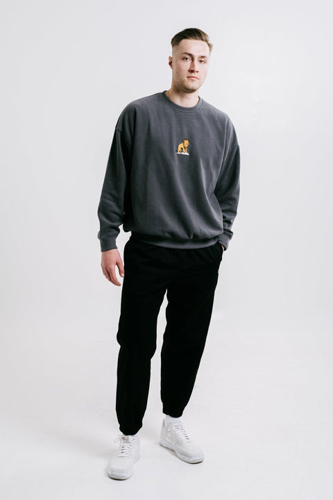 1. Unisex anthracite Lion Sweatshirt by Sossu worn by male model in studio setting