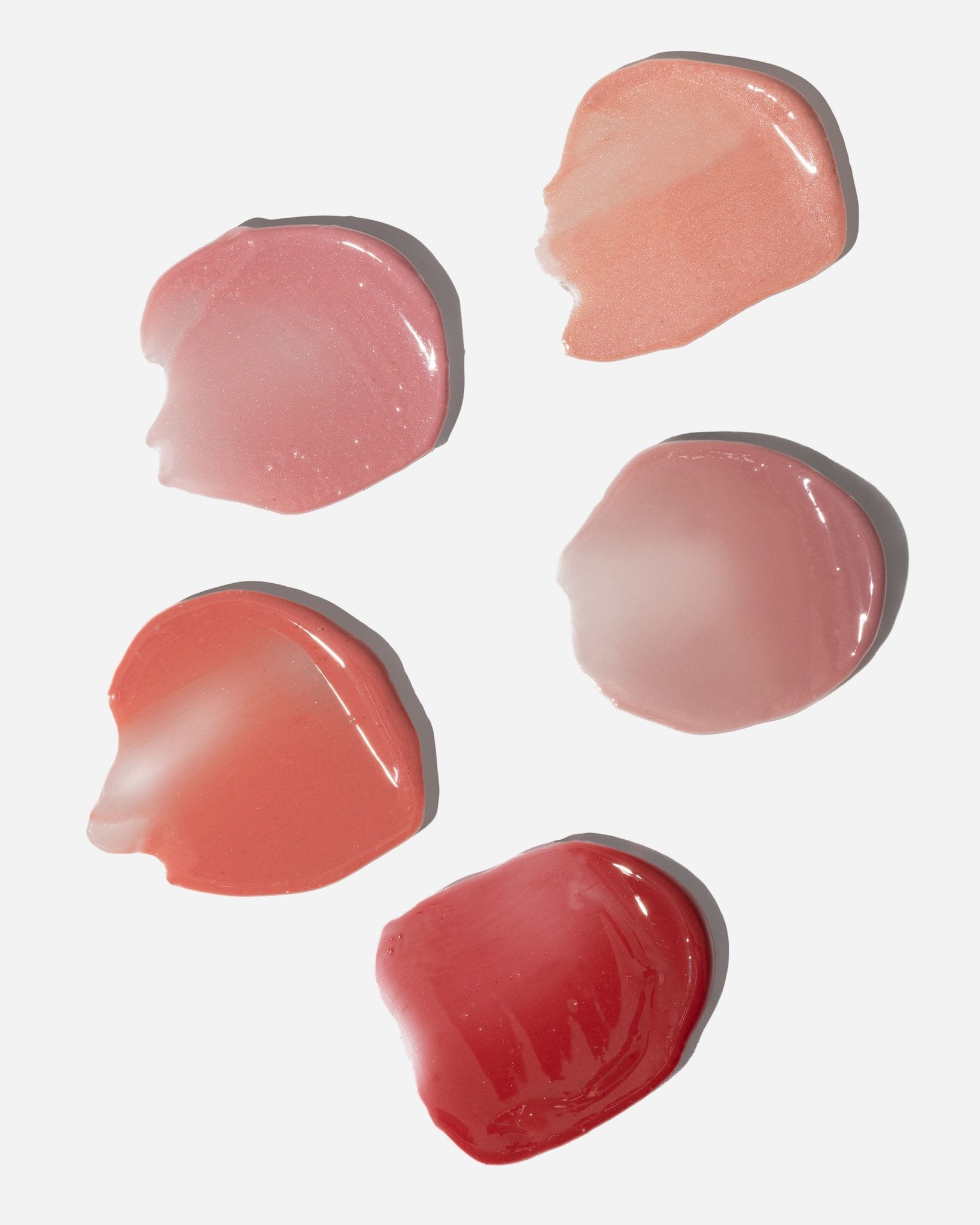 3. Assorted swatches of LUUV Lip Gloss Balm in various natural shades on white background