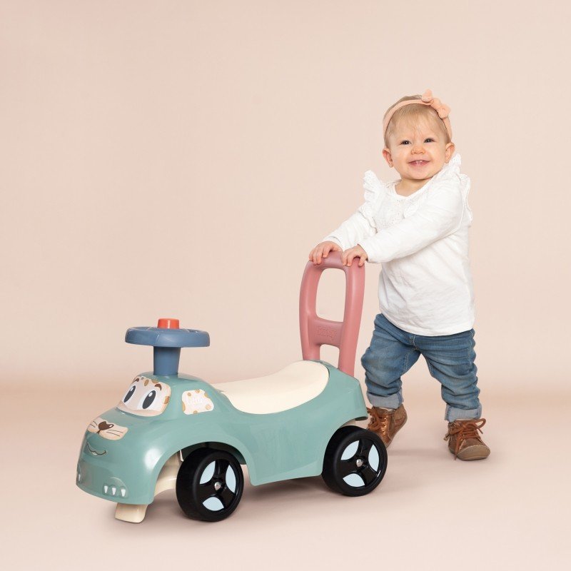 1. Toddler pushing Smoby Little Ride-on Pusher in pastel colors, indoor setting