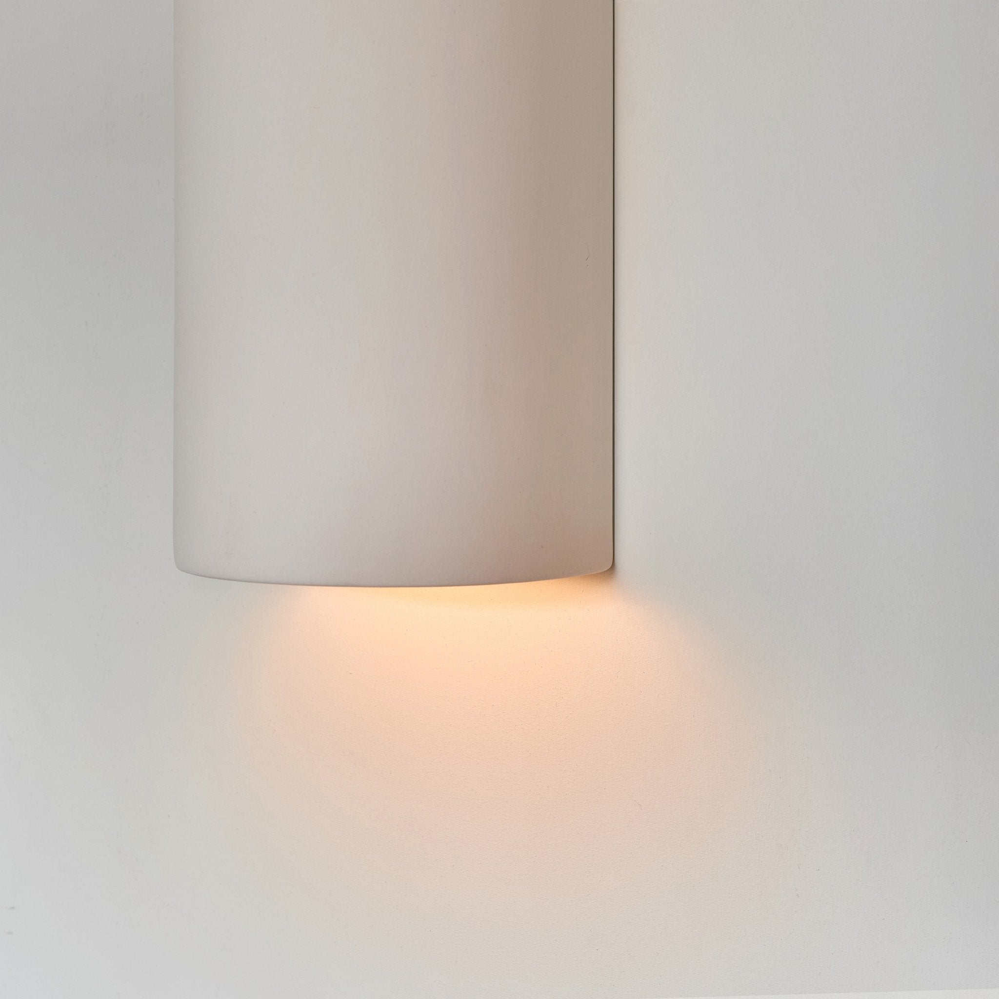 3. Close-up of ceramic wall light in extra matte white with warm light