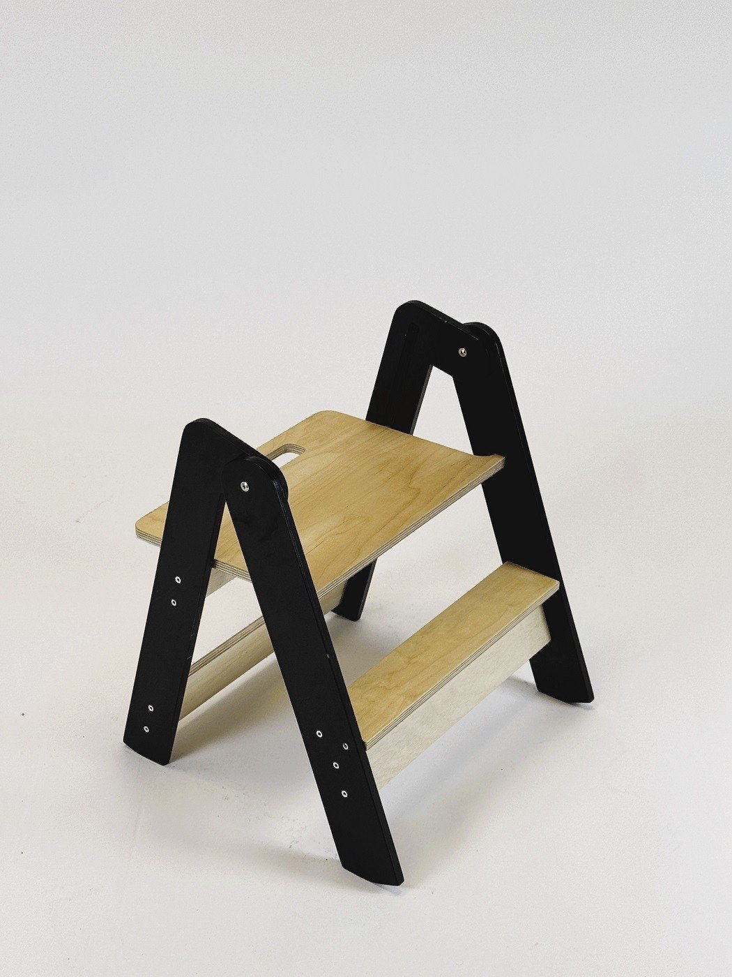 2. Wooden step stool with black sides and natural wood steps on white background