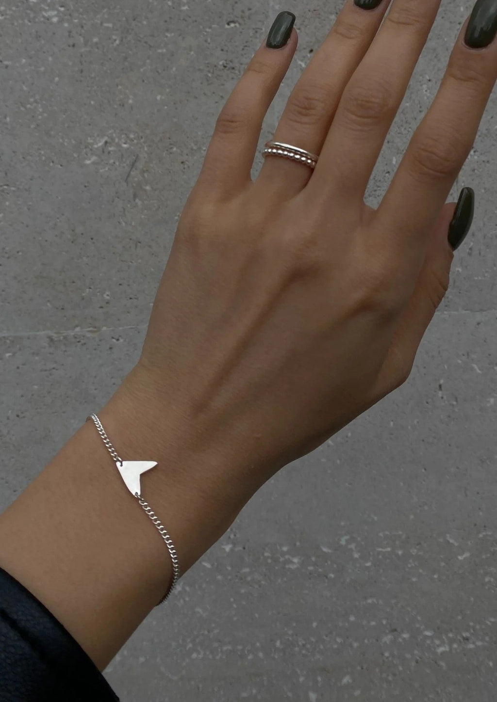 6. Women's Love Bracelet in silver worn with denim, showcasing casual and chic look