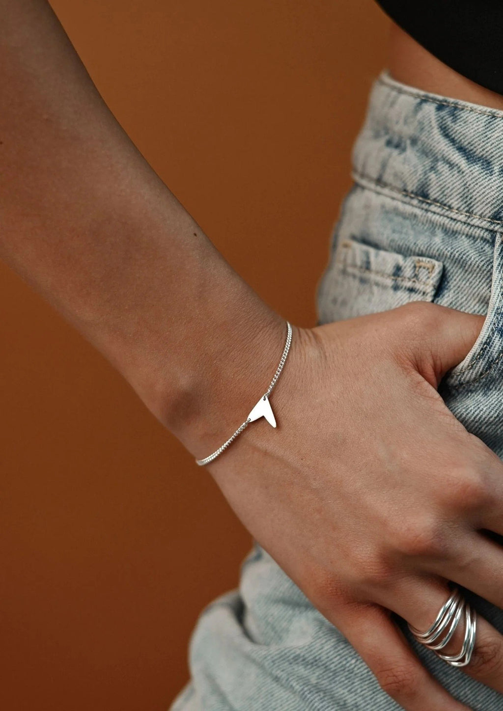 5. Women's Love Bracelet in silver worn with black outfit, highlighting elegant and versatile style