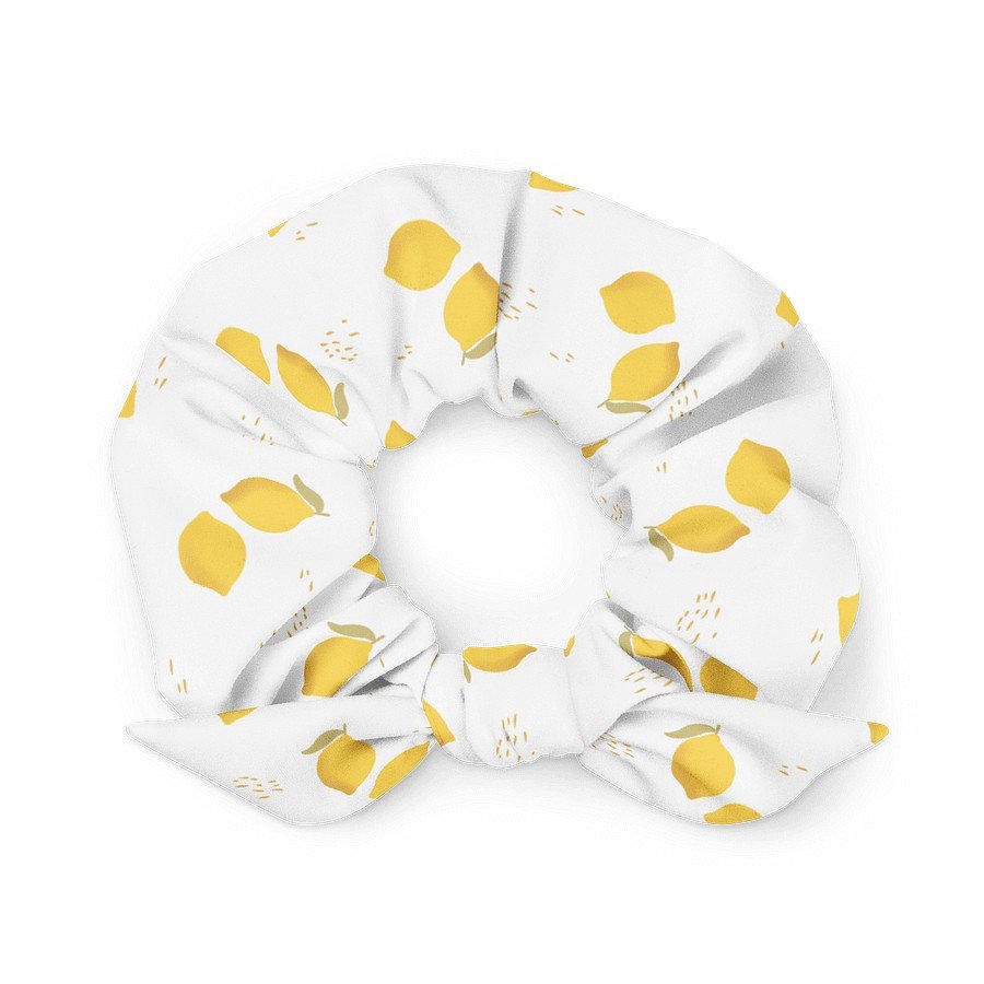 2. Eco-friendly white scrunchie featuring yellow lemon pattern, displayed in a flat lay to emphasize the soft microfiber fabric and elastic design