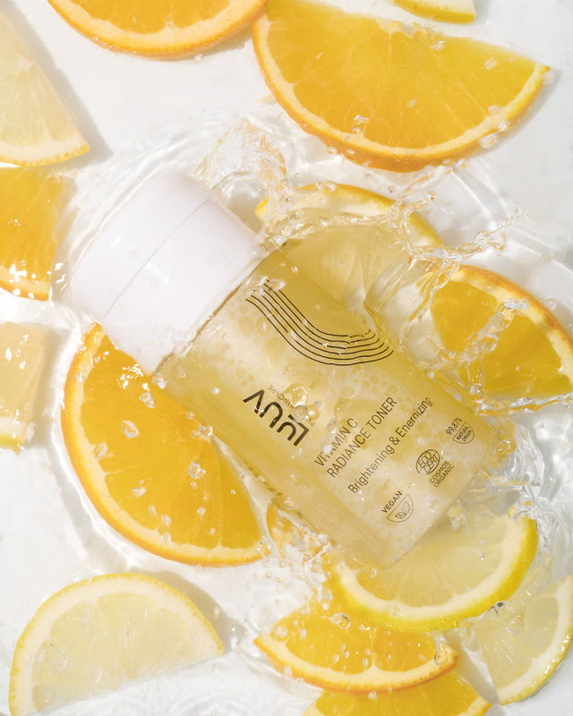 1. LUUV Vitamin C Radiance Toner bottle surrounded by fresh orange slices, highlighting its brightening and hydrating properties