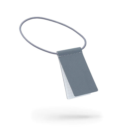 1. Grey MARCH Reflective Luggage Tag with writable surface, shown in studio setting
