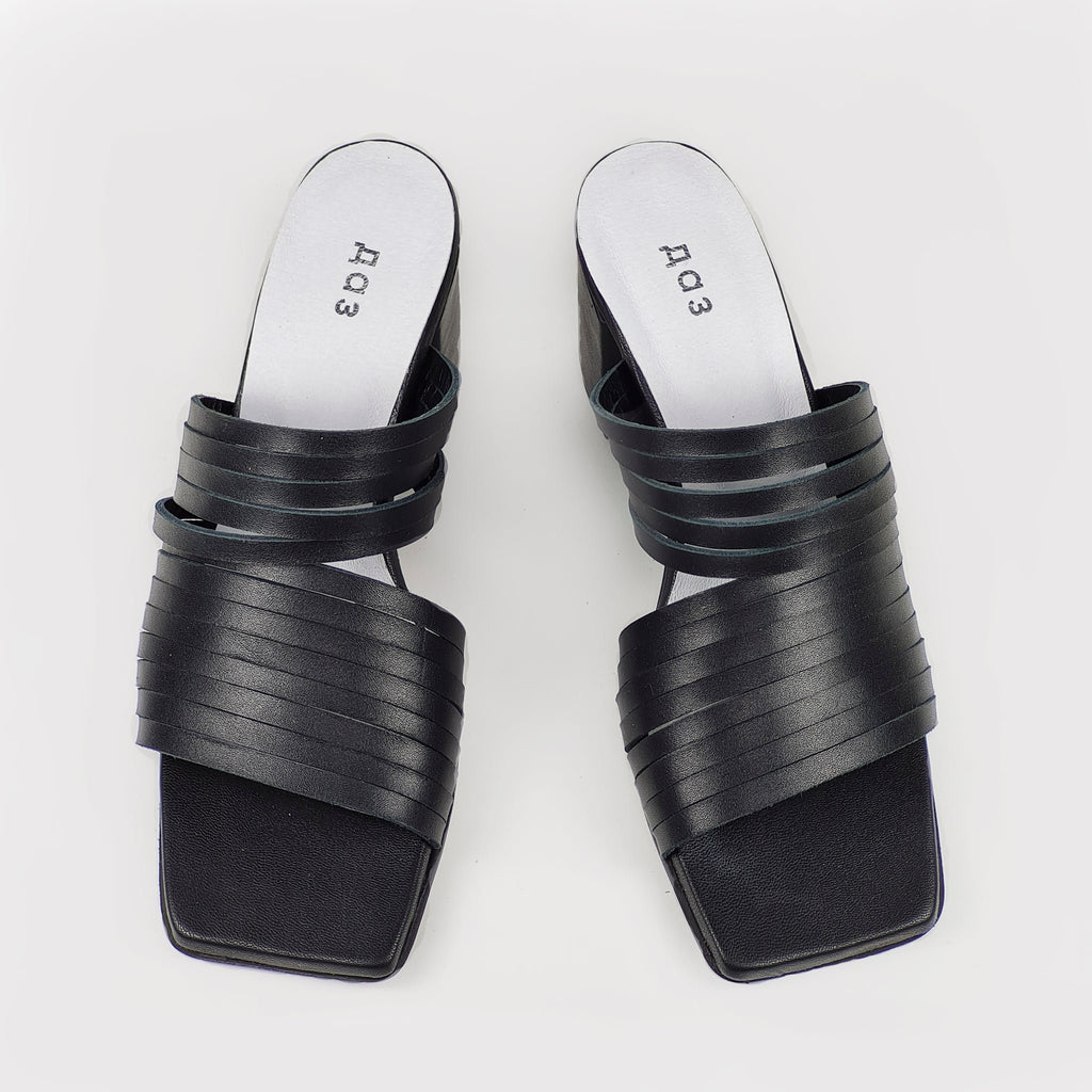 2. Women's black leather sandals by Daz Studio, top view highlighting strappy design and squared toe