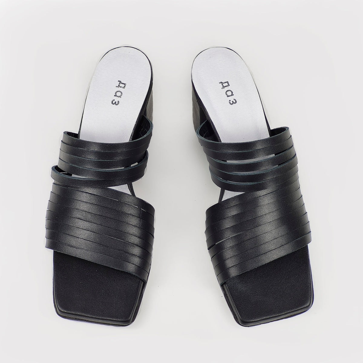 2. Women's black leather sandals by Daz Studio, top view highlighting strappy design and squared toe