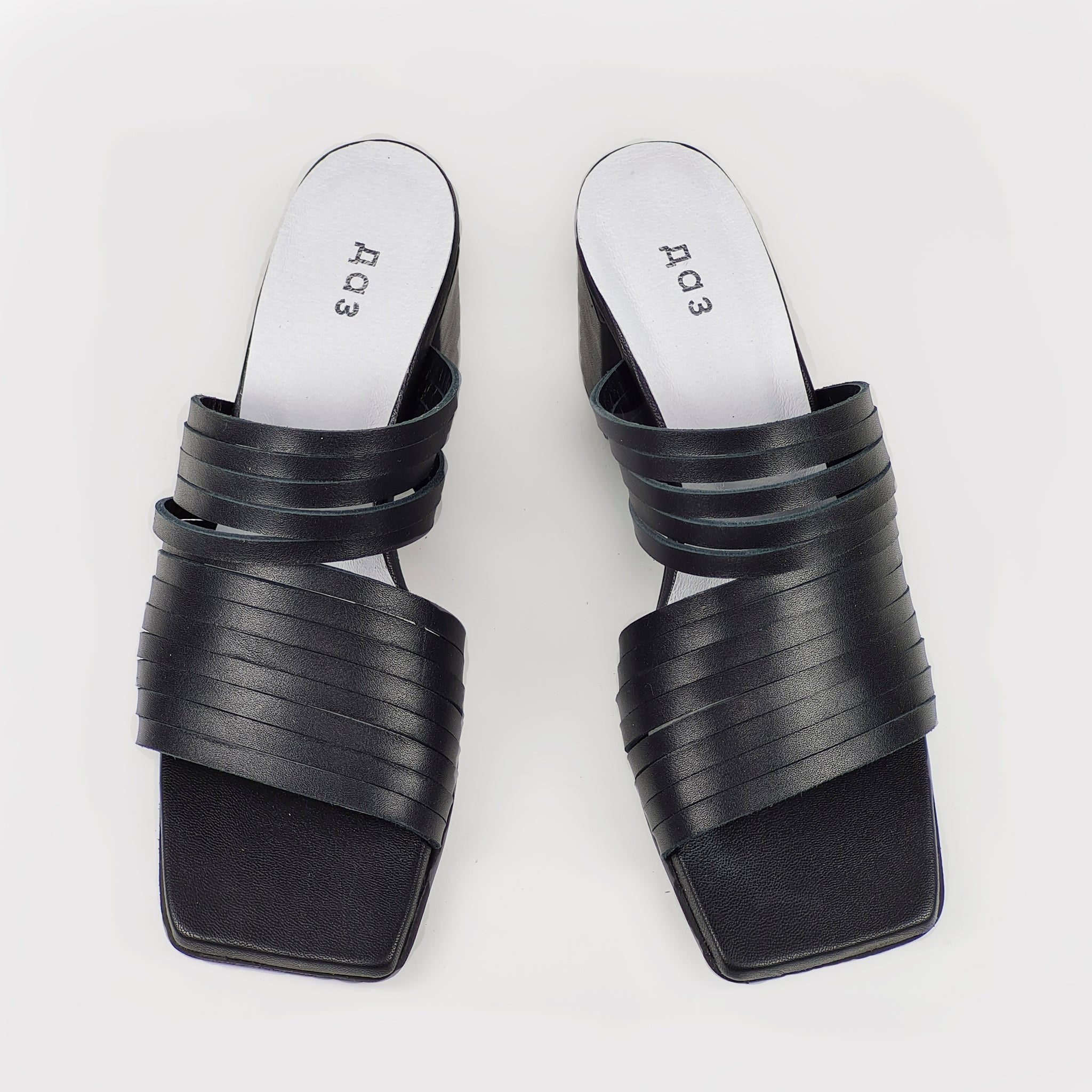 2. Women's black leather sandals by Daz Studio, top view highlighting strappy design and squared toe