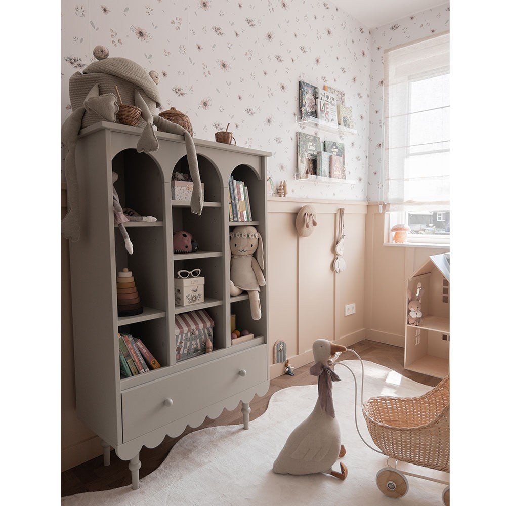 4. Playroom with a grey bookshelf and Dekornik's Flowers Minimini Wallpaper with delicate floral designs on the walls