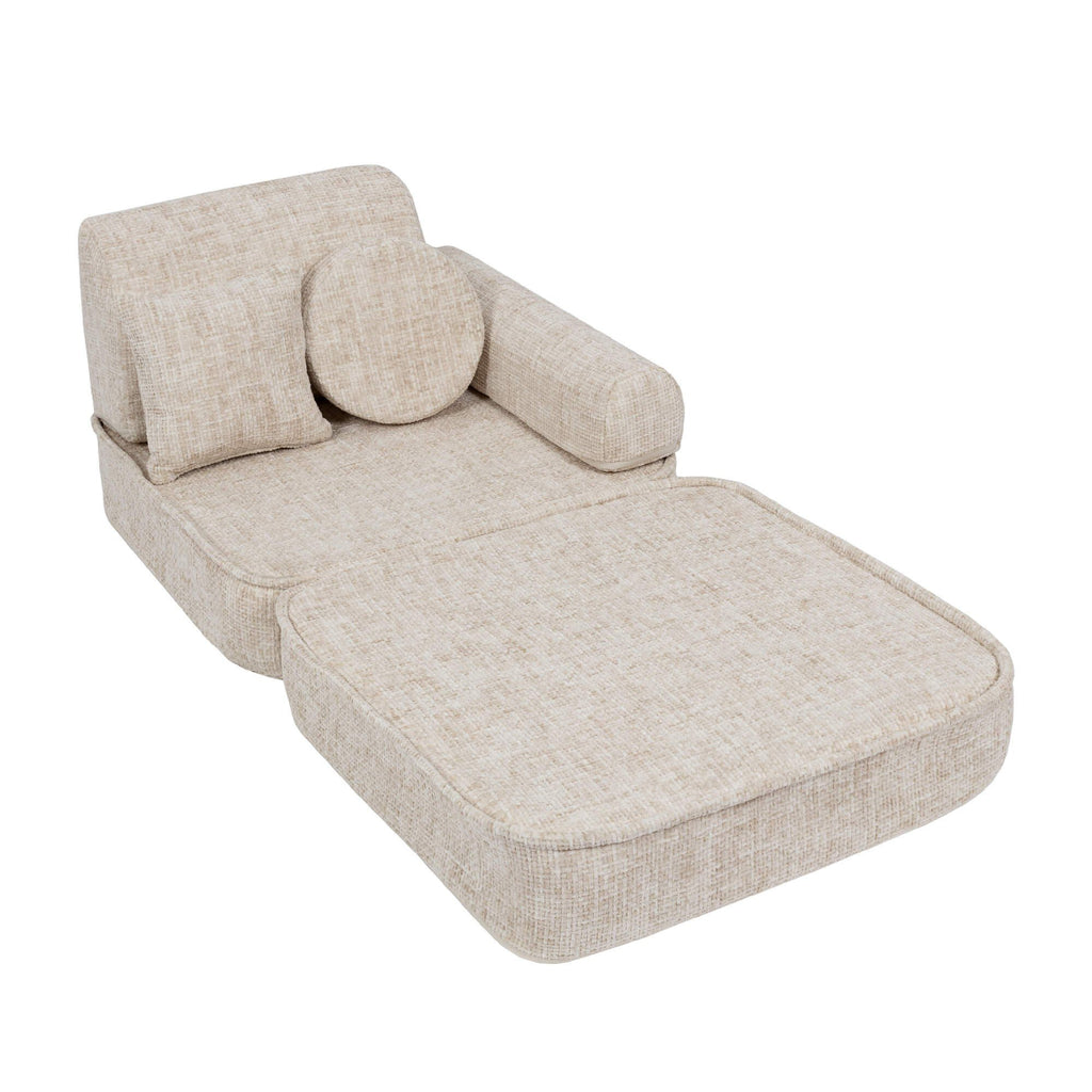 3. Beige modular children's sofa with extended seat, shown in a studio setting