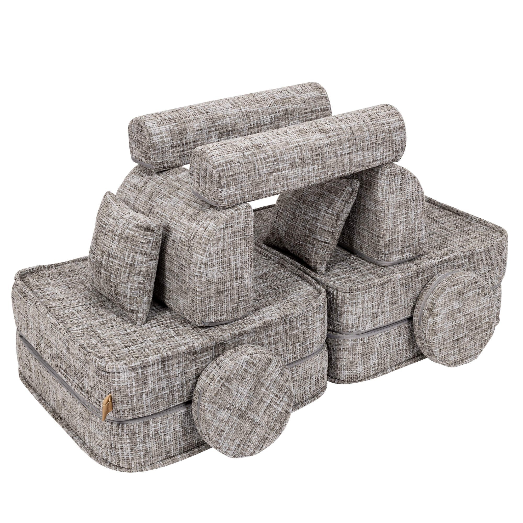 3. Medium modular sofa for kids in tangle moon grey arranged as a creative structure with cushions, shown in a studio setting