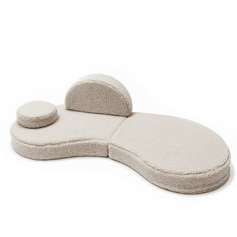 3. Modular kids' sofa in Bearly light gray with one backrest and one round cushion, arranged asymmetrically