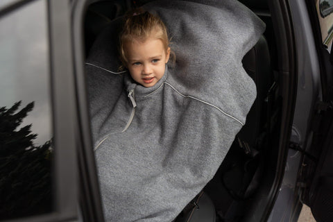 3. Child in grey merino wool poncho sitting in a car seat