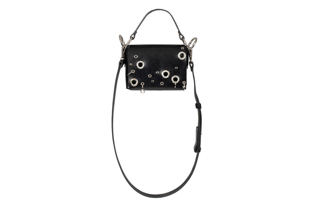 5. Studio shot of PYKOK Handbag Mia in black leather with metal details and adjustable strap