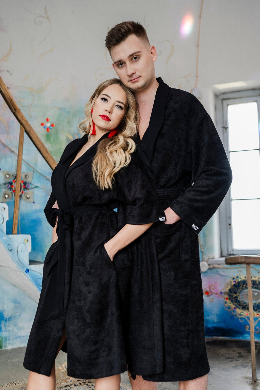 4. Couple in black bamboo terry robes with shawl collars standing in artistic room
