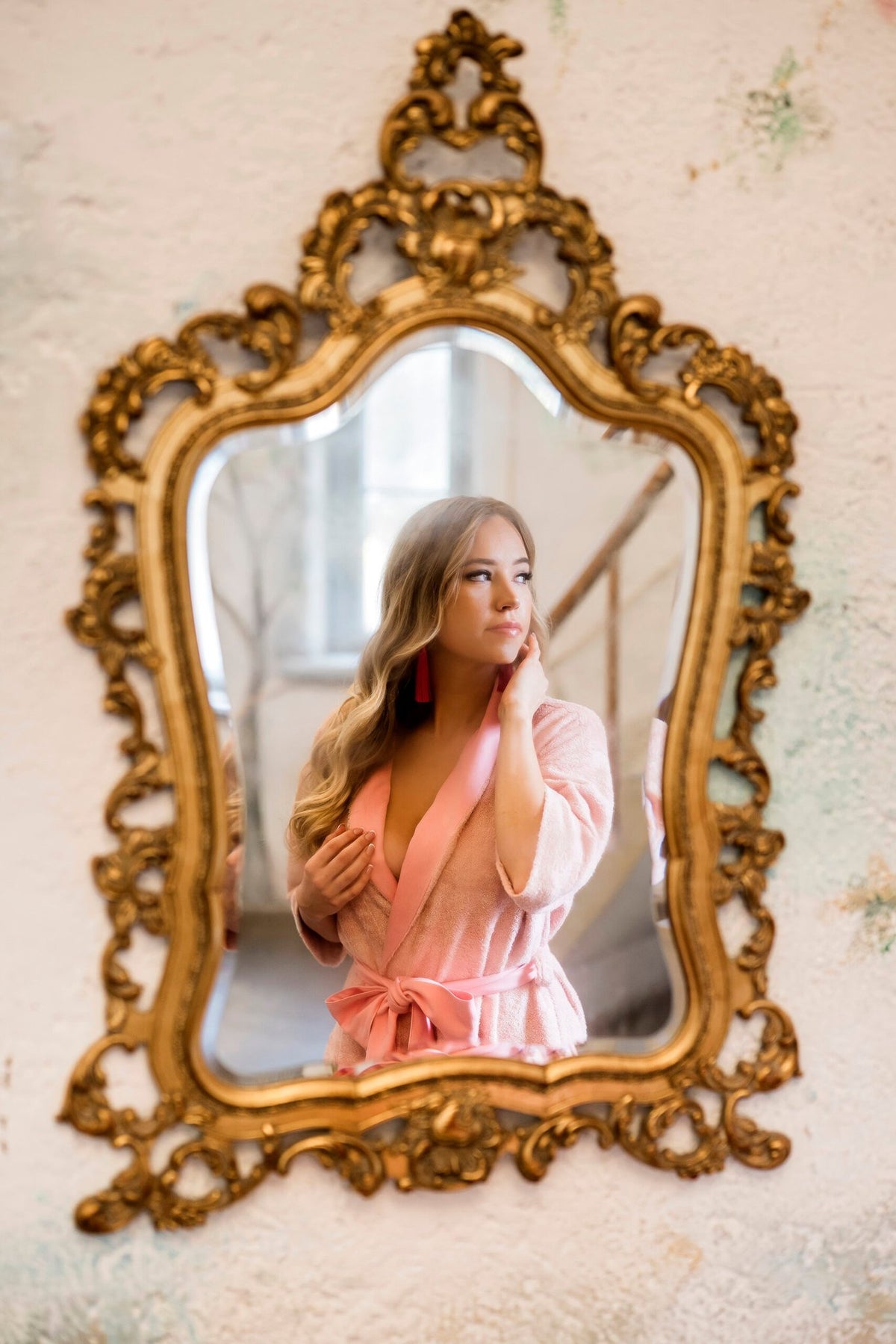 4. Woman in pink bamboo terry robe with shawl collar and bow belt reflected in ornate mirror