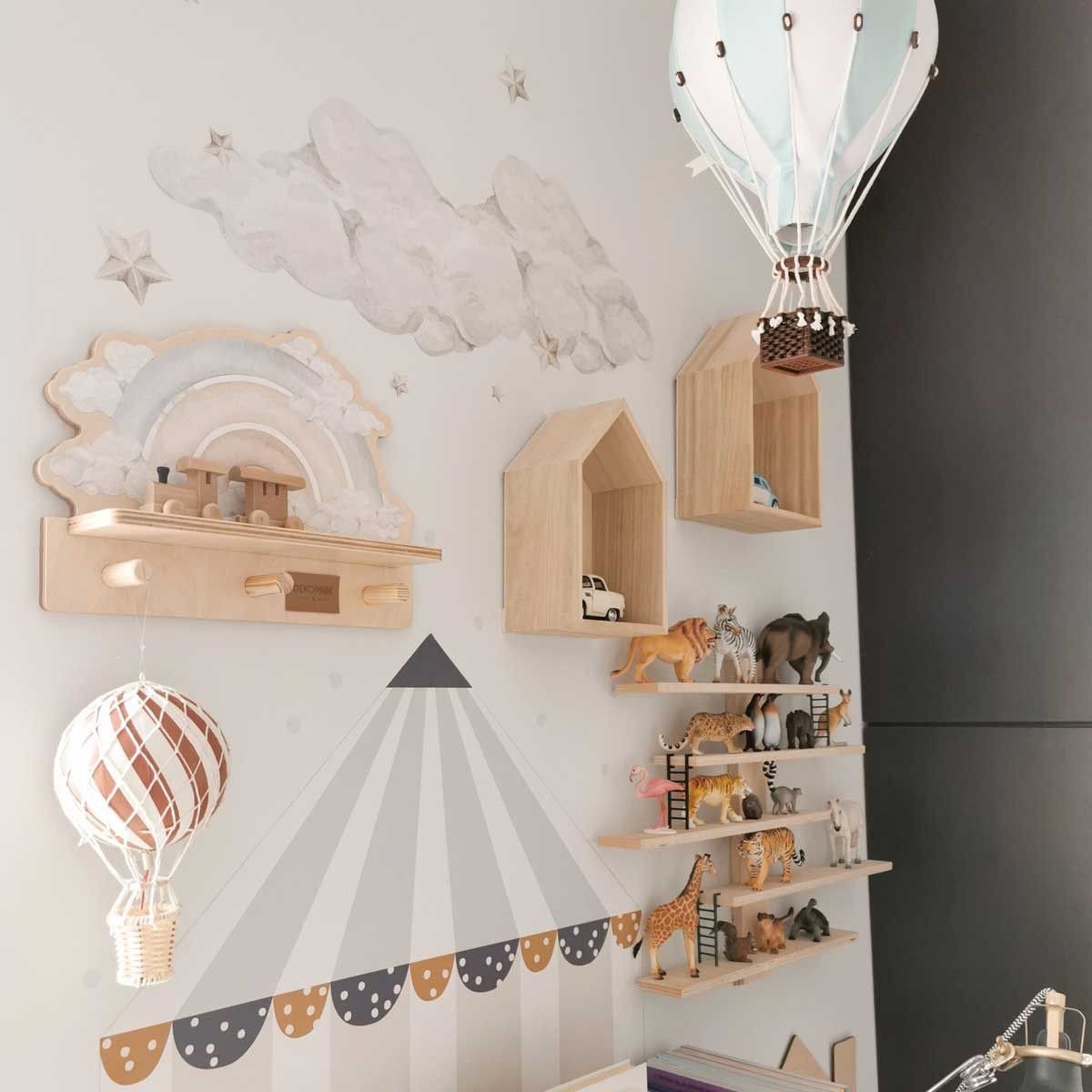 2. Children's room with mini wall shelf featuring blue rainbow design, surrounded by wooden house shelves and hot air balloon decor