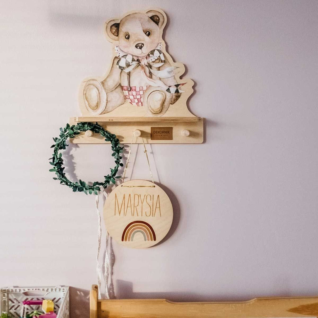 1. Dekornik mini wall shelf with teddy bear design mounted on wall, holding decorative items in a child's room