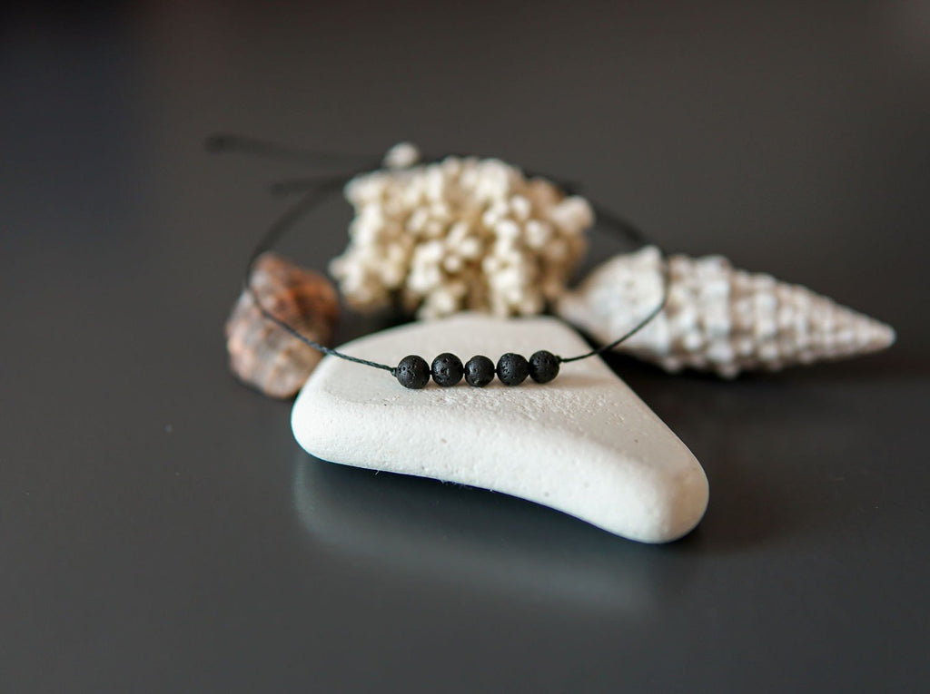 4. Close-up of Canary Lava minimalist lava stone bracelet with natural elements, showcasing polished lava rocks
