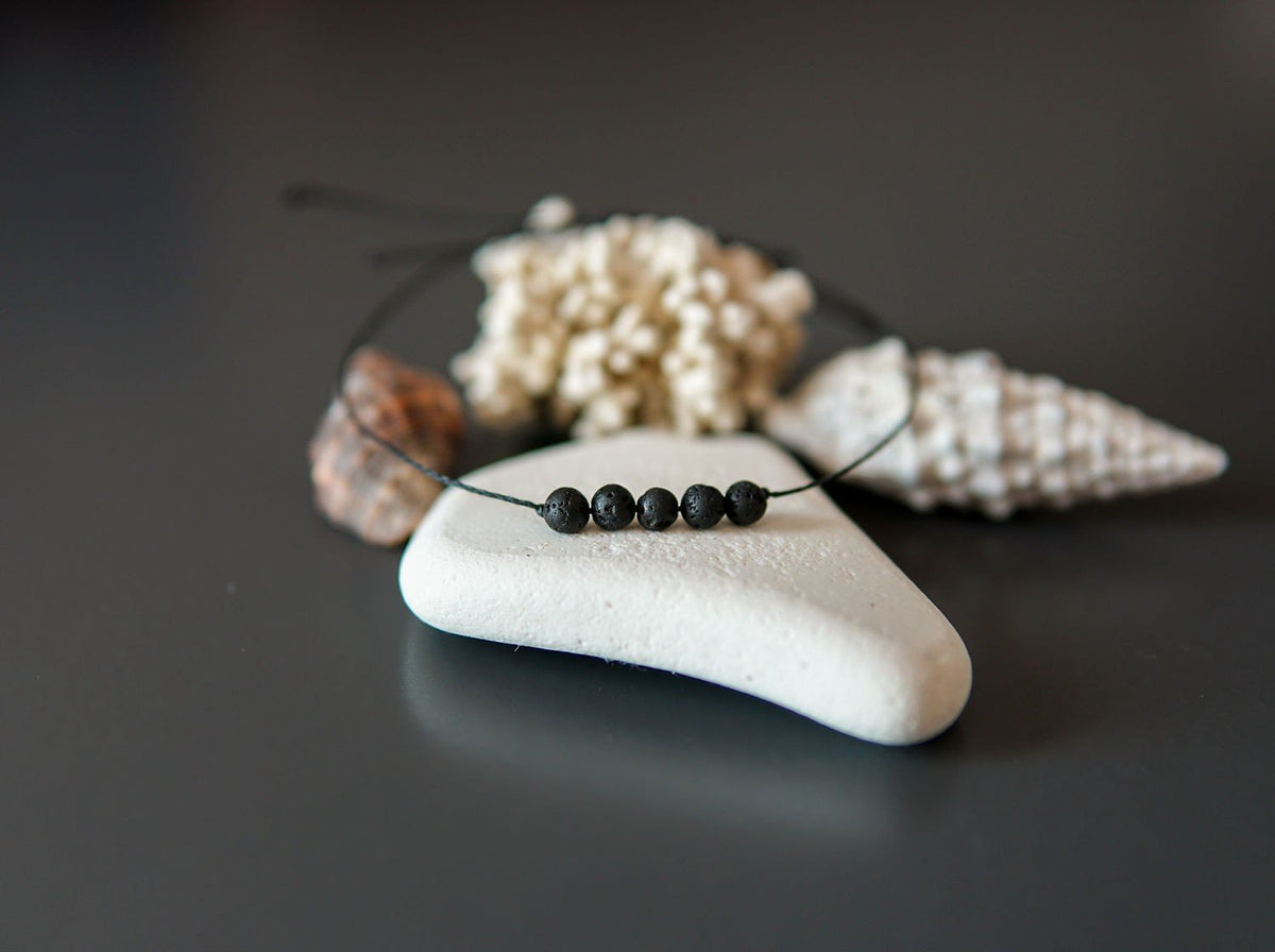 4. Close-up of Canary Lava minimalist lava stone bracelet with natural elements, showcasing polished lava rocks