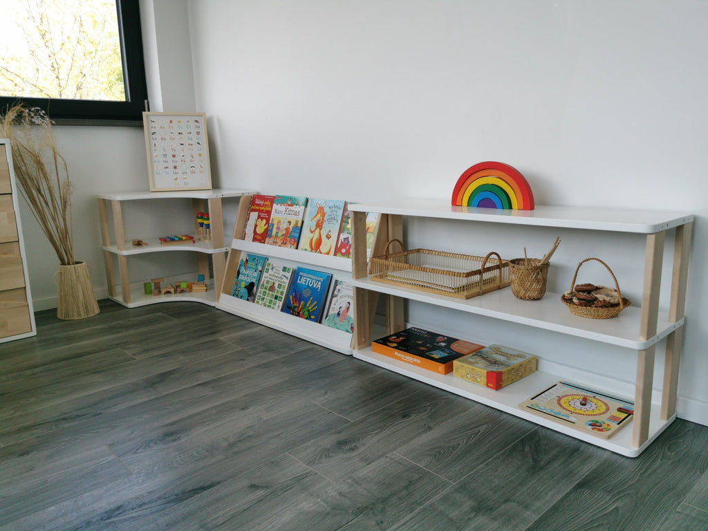 2. Modular Montessori bookshelf with two shelves displaying books and toys in a bright room