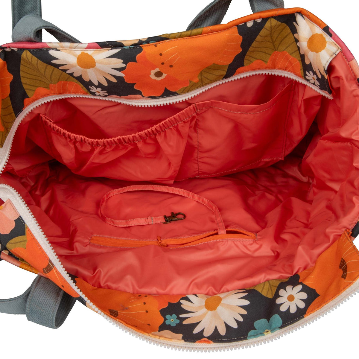 3. Close-up of the interior of the floral weekender bag, showing red waterproof lining and multiple pockets.