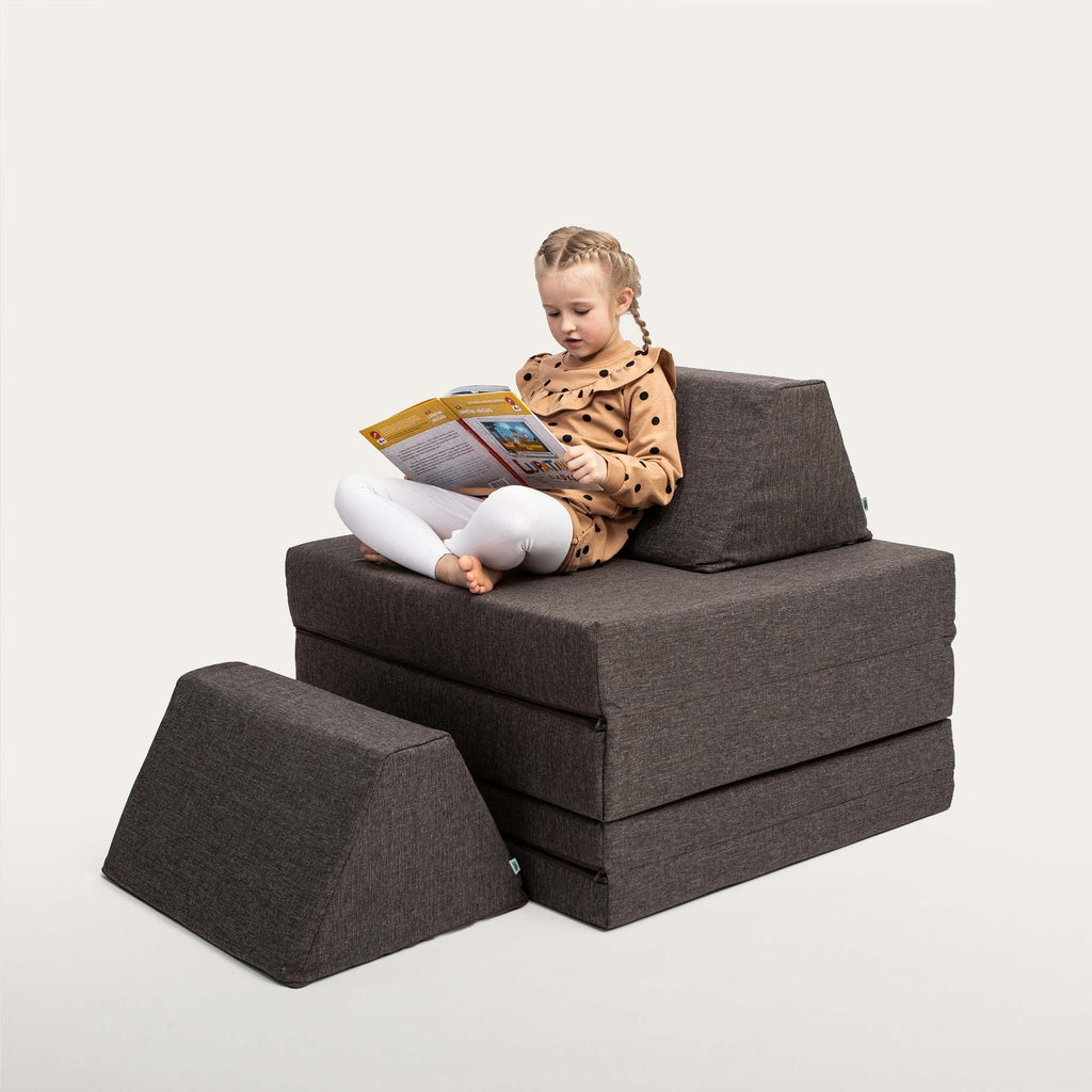 18. Child reading on Monboxy dark brown play mattress set stacked in a studio setting
