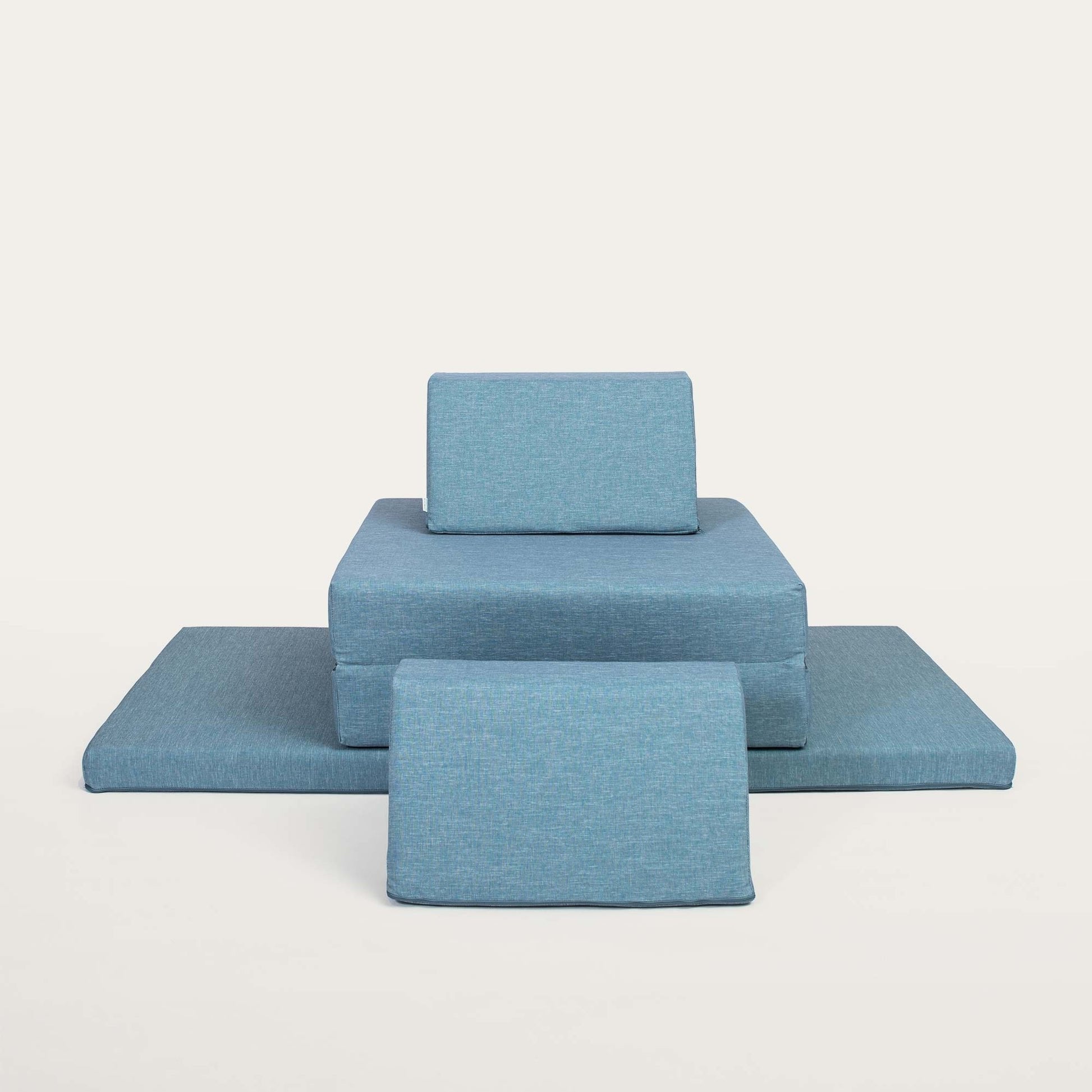 11. Turquoise Monboxy play mattress set with trapezoidal pillows on a plain background