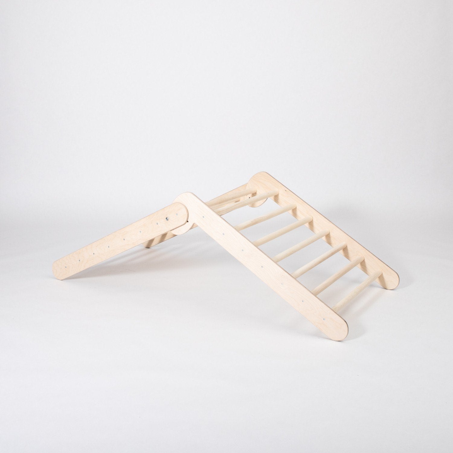 5. Montessori Climbing Triangle in studio setting showing its two slope levels and wooden structure