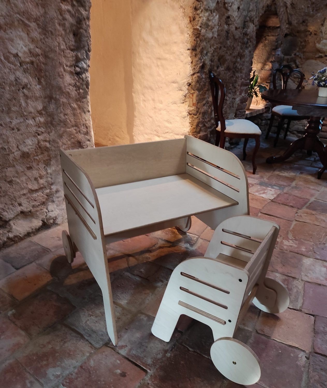 2. Luula Montessori table and chair set in rustic setting, showcasing birch plywood construction and adjustable height features
