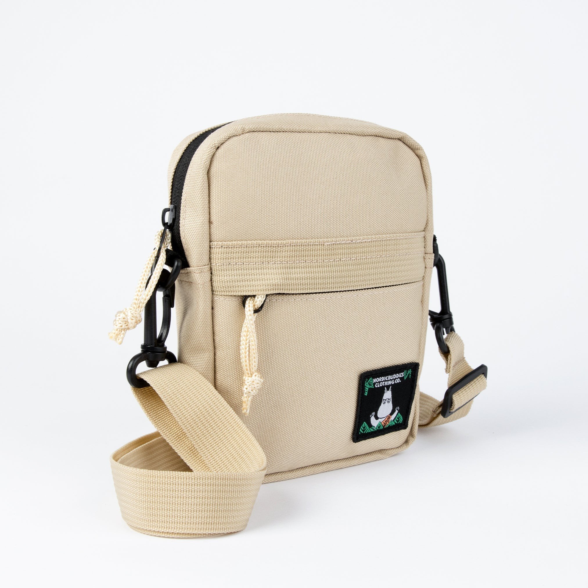 3. Side view of beige Moomin 80 cross body bag by NordicBuddies showing strap and zipper details