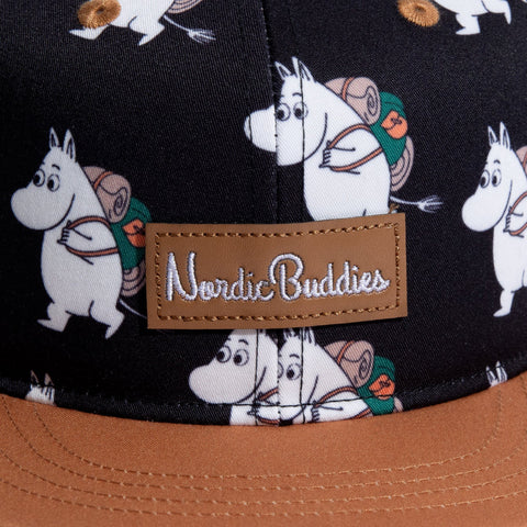 3. Close-up of NordicBuddies logo on Moomin Adventure Kids Flat Cap with Moomin character pattern