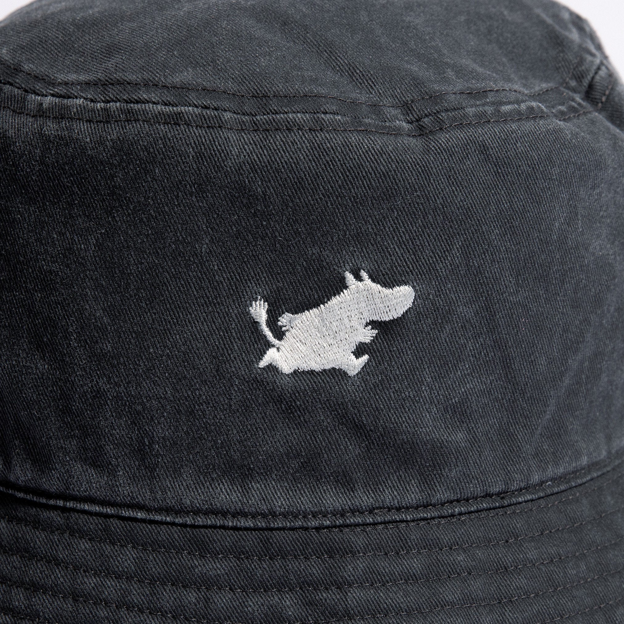 4. Close-up of embroidered Moomin character on black washed denim bucket hat