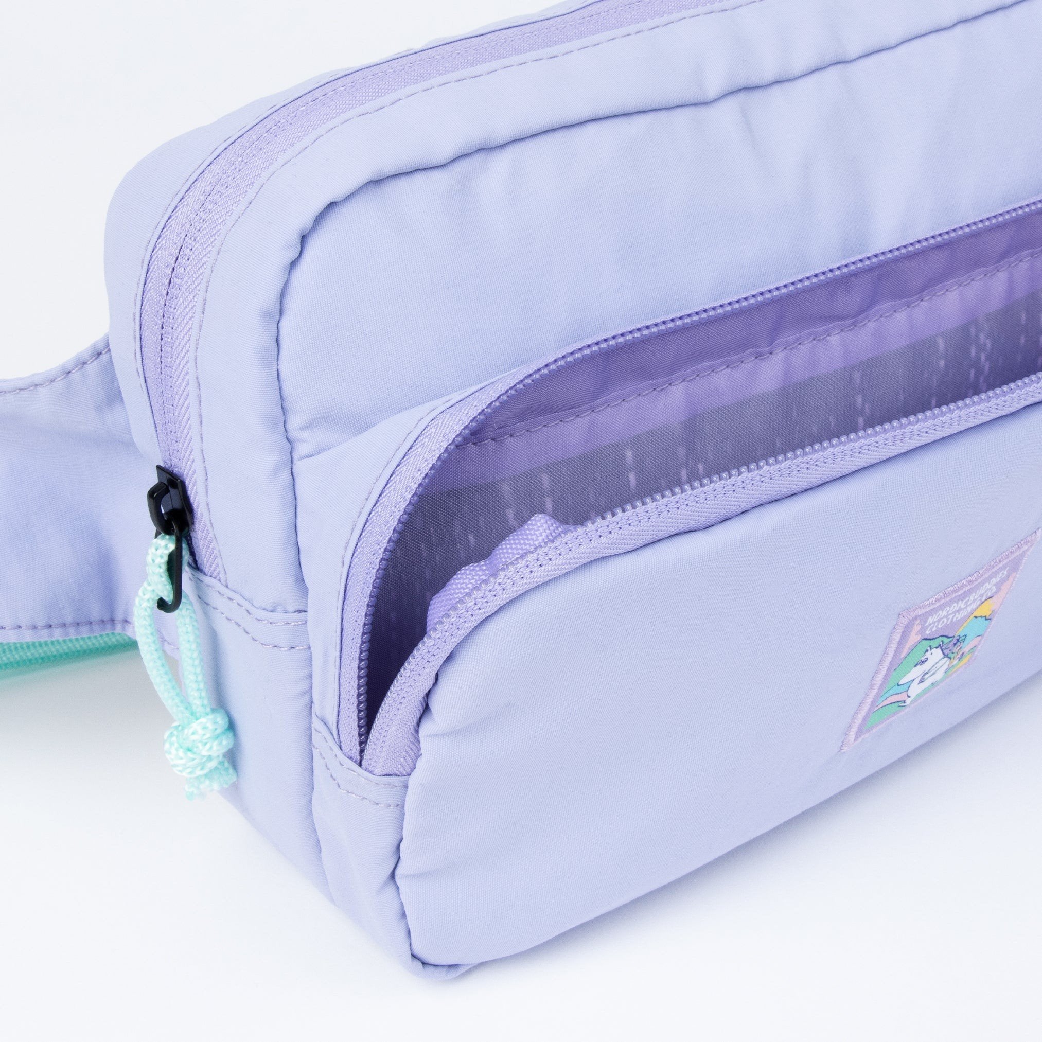 3. Close-up of open front pocket on lavender waist bag showing interior
