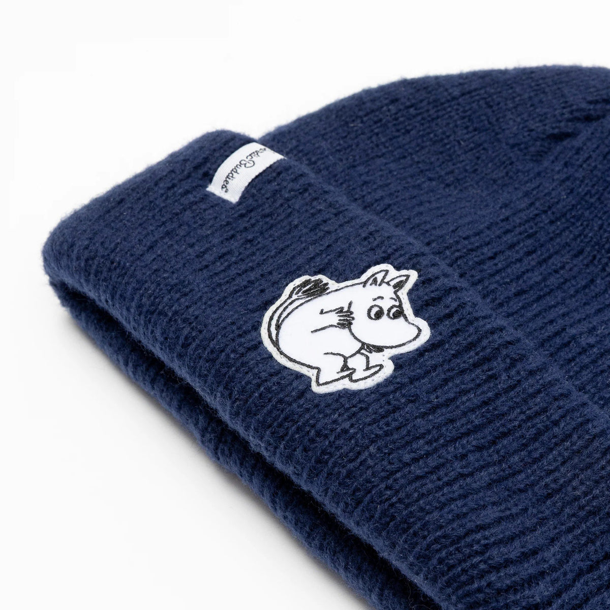 3. Close-up of navy Moomintroll beanie showing felt patch and NordicBuddies logo on ribbed acrylic fabric