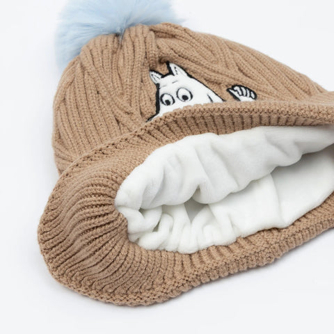 3. Close-up of brown Moomintroll winter beanie showing soft white fleece lining and blue pom-pom