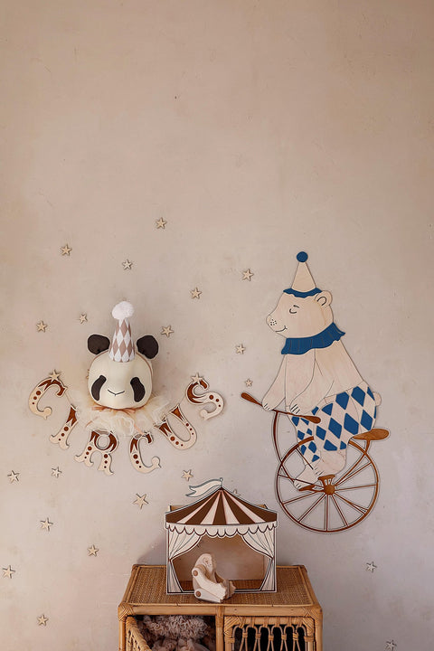 4. Wooden wall garland spelling 'CIRCUS' with a panda head and bear on a unicycle in a child's room