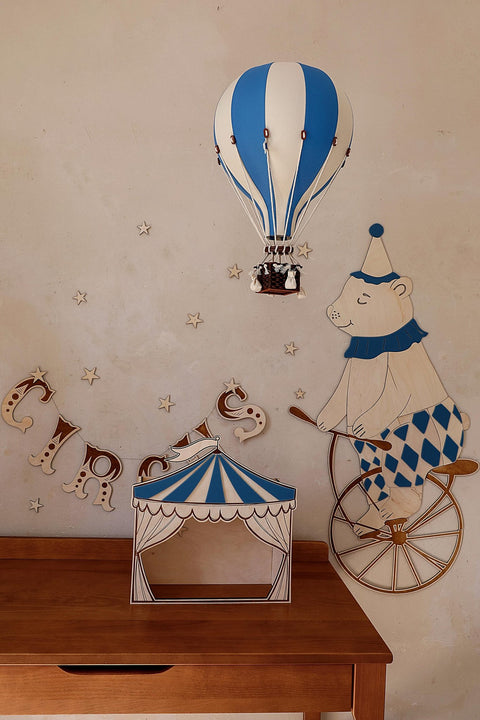 2. Wooden wall garland spelling 'CIRCUS' with a bear on a unicycle and hot air balloon in a child's room
