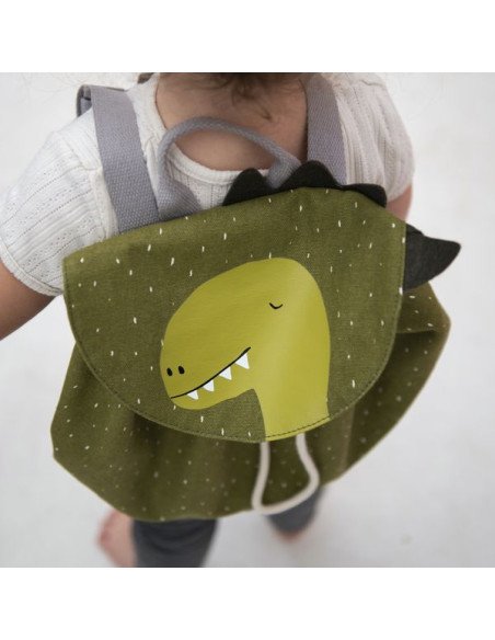 3. Close-up of child wearing green dinosaur-themed mini backpack with visible drawstring and black spikes