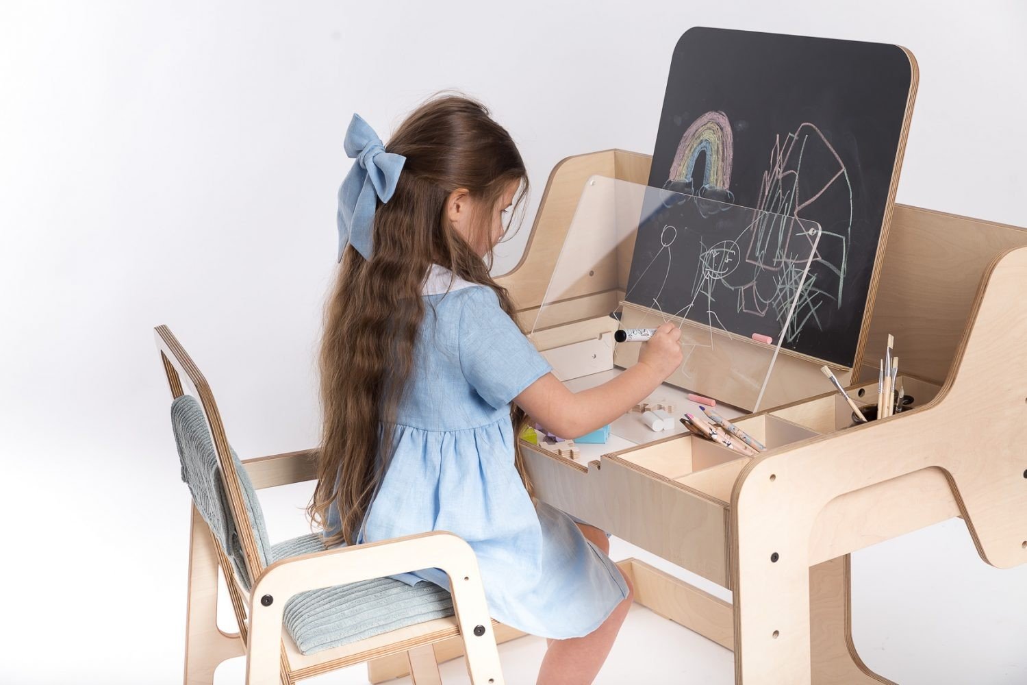 8. Girl drawing on Luula table with chalkboard and acrylic board, showcasing artistic expression