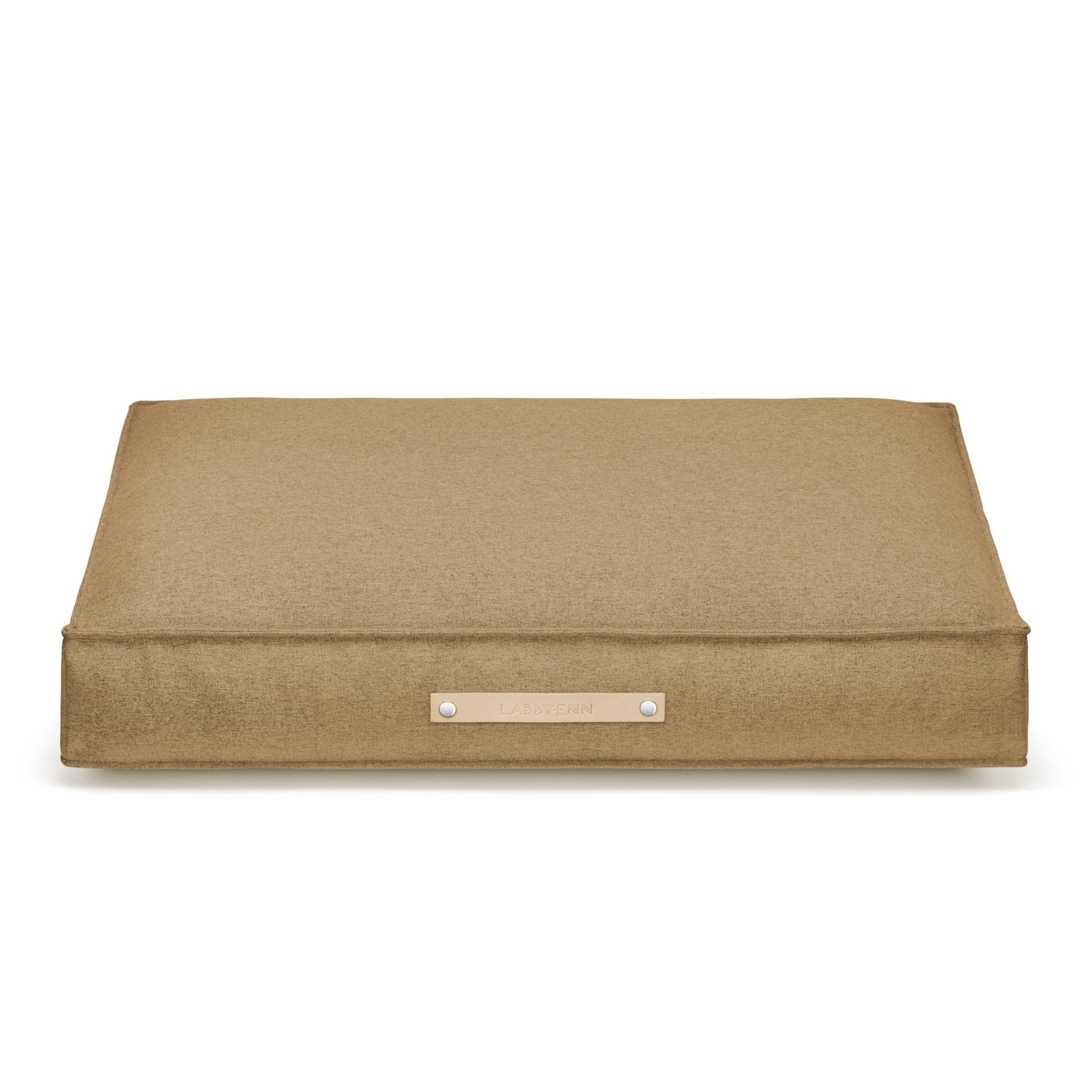 2. Labbvenn Møvik Cushion in biscuit color with leather belt and embossed logo, shown on a white background highlighting its rectangular shape and minimalist design