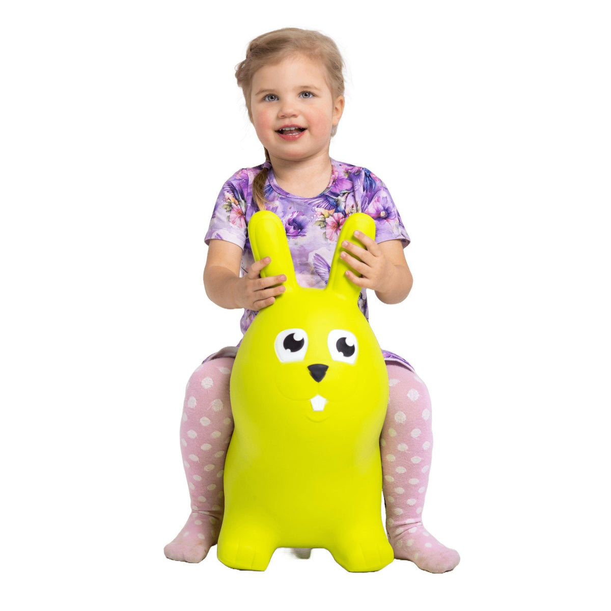 1. Young girl sitting on green bunny hopper toy wearing purple floral dress and pink polka dot leggings