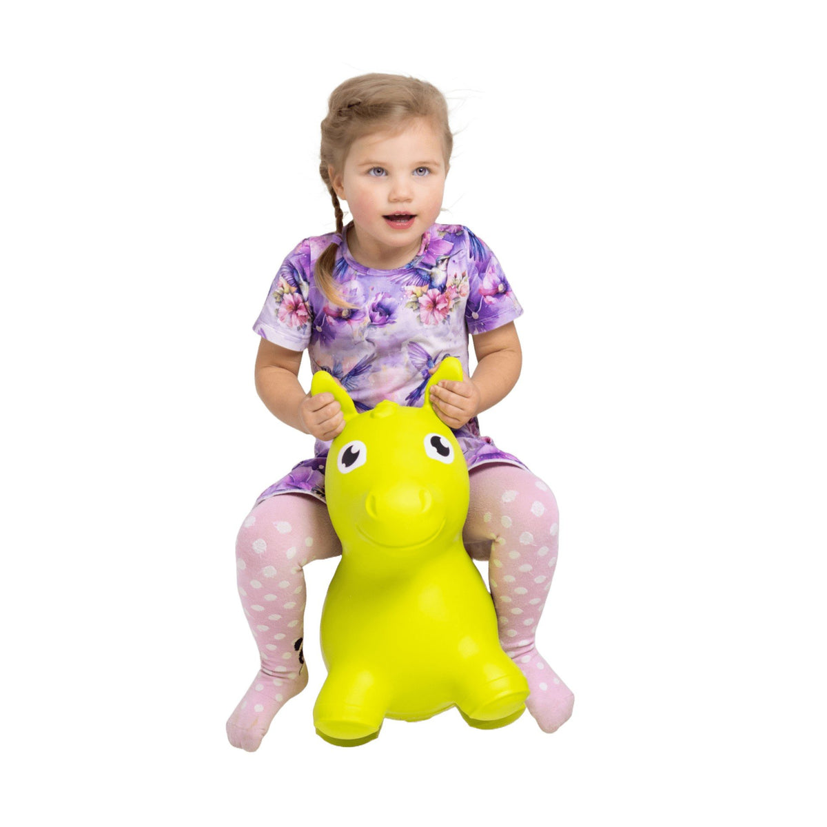 1. Young girl in purple floral dress and pink polka dot tights riding green horse-shaped hopper toy indoors