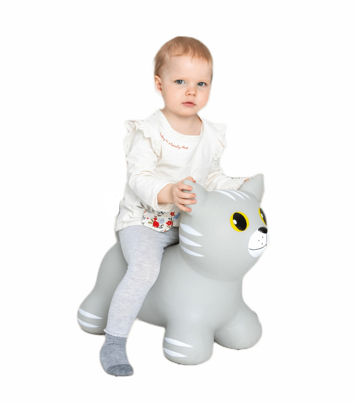 1. Child sitting on grey cat-shaped hopper toy by Gerardo's Toys, wearing white top and grey leggings, on white background