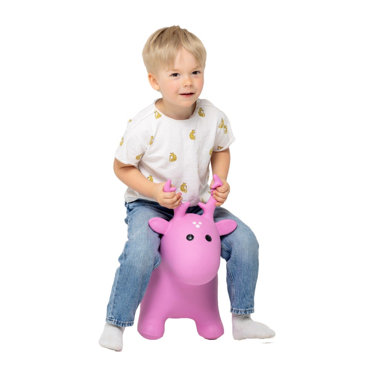 2. Boy in white t-shirt with yellow print and jeans sitting on pink moose hopper toy
