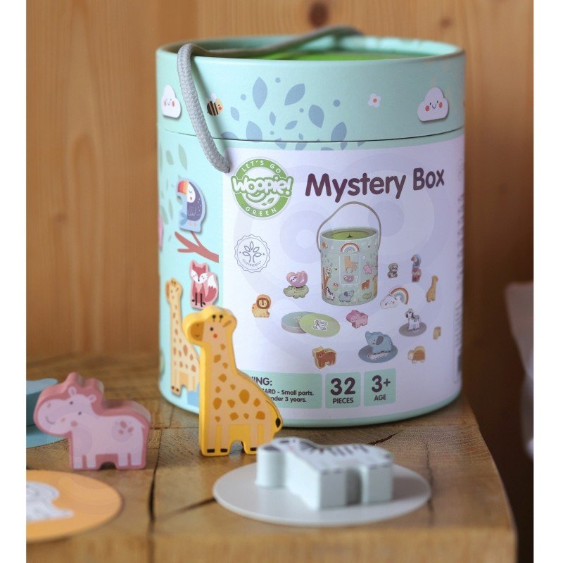 3. Woopie Mystery Box on wooden surface with giraffe and other animal shapes