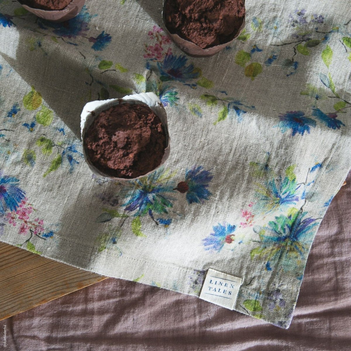 7. Close-up of floral linen napkin with muffins, highlighting texture and pattern